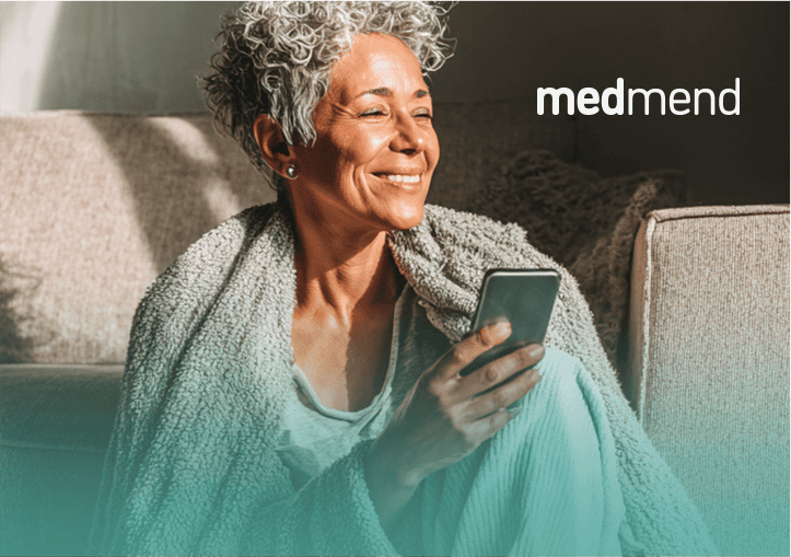 Elderly woman using smartphone for telehealth consultation.