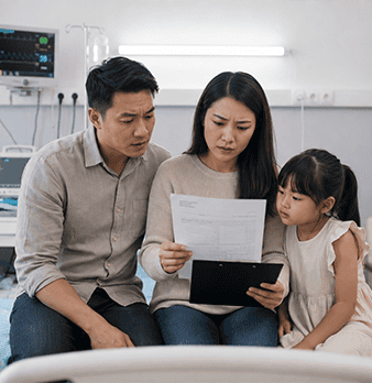 Family reviewing medical documents in a healthcare setting.