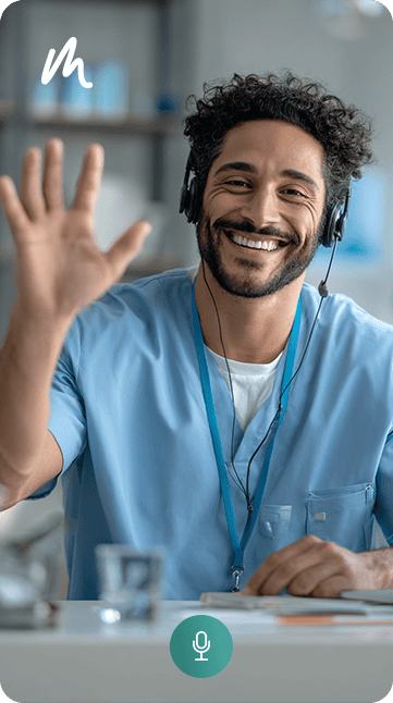 Smiling healthcare professional with headset waving during virtual consultation.